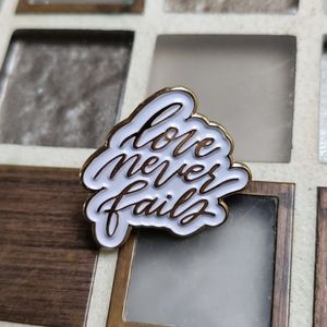 "Love Never Fails" Lapel pin Vtg